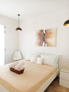 a bedroom with a bed with white walls at Kolossoi Guest House in Càbras +48 photos