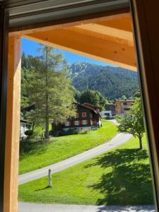 een uitzicht vanuit een raam van een dorp met een weg bij Appartements Zint in Sankt Gallenkirch