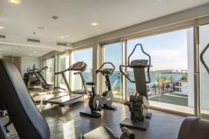 a gym with cardio machines and a view of the ocean at Kyrat Amarac - Adults Only in Cala Millor