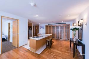 a kitchen with a sink and a counter top at lebua at State Tower in Bangkok