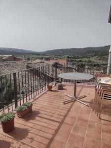 a picnic table on a patio with a view at El Desván del Campanero in Murillo de Gállego