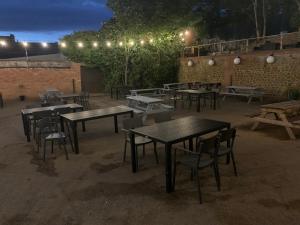 a group of tables and chairs in a patio at night at The Wash & Tope in Hunstanton