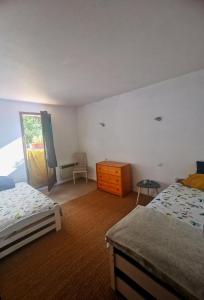 a bedroom with two beds and a dresser in it at Les chambres de Sophie in Chalabre