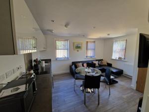 a living room with a couch and a table at 7 Burnby Close,Leeds,LS14 1GA in Leeds