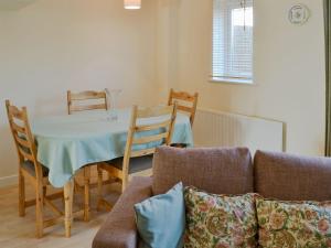 a living room with a table and a couch at Turnstone in Seahouses