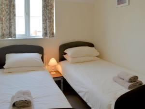 two beds sitting next to each other in a room at Turnstone in Seahouses