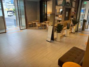 - un hall avec un canapé, des tables et des chaises dans l'établissement Bonatree Hotel, à Busan