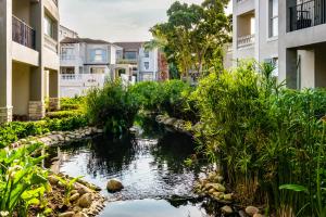 a creek in the middle of a city with buildings at Belina - Bougain Villas Premier in Cape Town