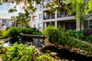 a building with a river in front of a building at Belina - Bougain Villas Premier in Cape Town