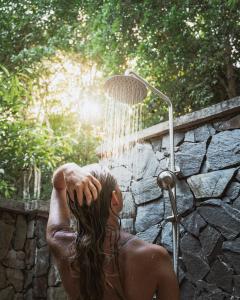 a woman laying in front of a shower at Valley Village Phu Quoc in Phu Quoc