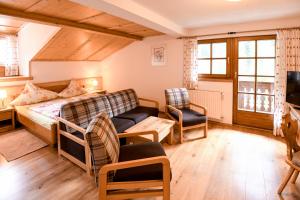 a bedroom with a bed and a couch and a tv at Strickhof in Schladming