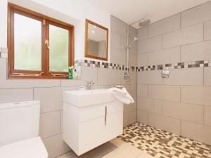 a white bathroom with a sink and a toilet at Shadycombe Lodge in Salcombe