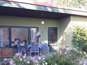 a house with a table and chairs on a patio at Ferienbungalow Haus Rolf _ Objekt in Papendorf