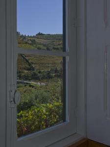 an open window with a view of a field at Casa de Cambres in Lamego