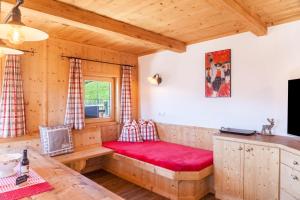 a room with a red bench in a cabin at Berghütte Ahornblick in Hippach