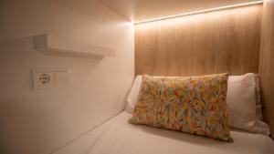 a bedroom with a bed with a pillow on it at Veranera Hostel in Estepona
