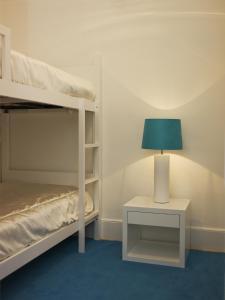 a bedroom with a bunk bed and a table with a lamp at Casa de Cambres in Lamego