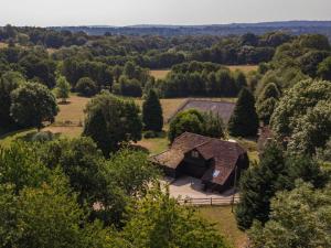 an aerial view of a barn in a field with trees at Spilstead Barn in Sedlescombe