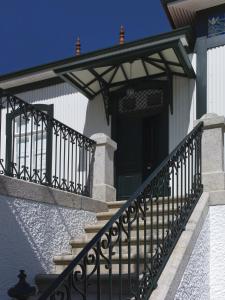 a porch with a black railing on a house at Casa de Cambres in Lamego