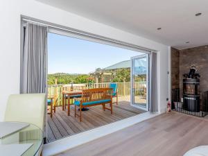 a living room with a large sliding glass door with a table at Inverspey in Kingston