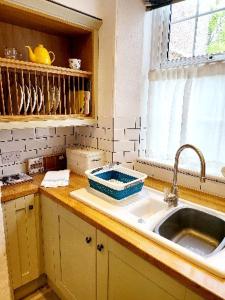 a kitchen counter with a sink and a window at 8 Duke Street - Launceston Cornwall in Launceston