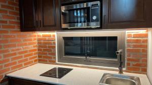 a kitchen with a sink and a microwave at Eco nest in Hanoi