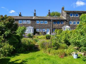 a house with a garden in front of it at Club House in Hebden Bridge