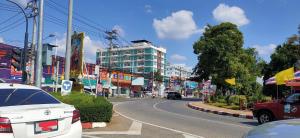 a city street with cars parked on the road at Chiangmai residence in Chiang Mai