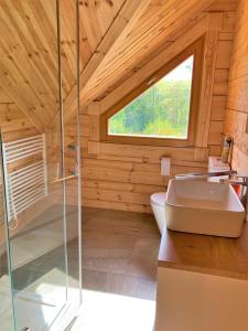 La salle de bains est pourvue d'une baignoire, d'un lavabo et d'une fenêtre. dans l'établissement Chata Green, à Veľká Lomnica