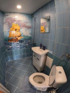 a bathroom with a white toilet and a sink at By The Cathedral, 1 bed flat in Varna City