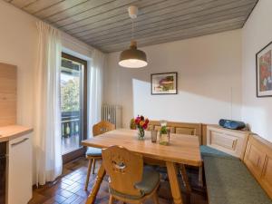 a dining room with a wooden table and chairs at Ferienwohnung Panoramablick in Oberaudorf
