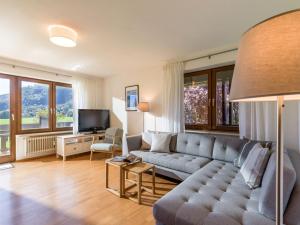 a living room with a couch and a tv at Ferienwohnung Panoramablick in Oberaudorf
