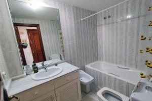 a bathroom with a sink and a tub and a toilet at Avenida España 154 - AE11 in Estepona