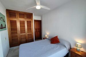 a bedroom with a bed and a ceiling fan at Avenida España 154 - AE11 in Estepona