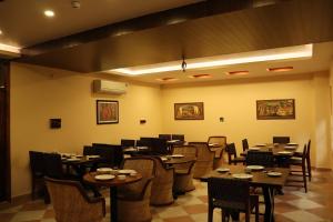 a dining room with tables and chairs in a restaurant at BALARWA HAVELI in Jodhpur