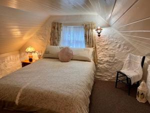 Un pat sau paturi într-o cameră la Tosses Cottage - Secluded cottage with hot tub