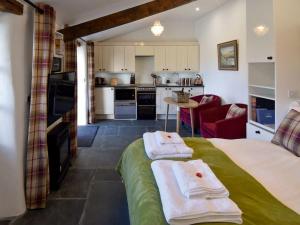 a bedroom with a bed with two towels on it at Field House Bothy - UK12571 in Borrowdale Valley
