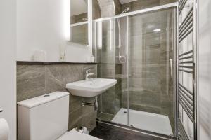 a bathroom with a toilet and a sink and a shower at Lux Georgian House in Yorkshire - Parking - Garden in Wakefield +76 photos