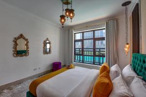 a bedroom with a large bed and a window at Durrani Homes - Heaven on Earth in Dubai +32 photos