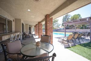 a patio with a table and chairs and a pool at Luxury Home Near Las Vegas Strip and Airport. in Las Vegas