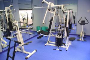 a gym with several tread machines in a room at Hôtel Restaurant l'Hirondelle in Dunkerque