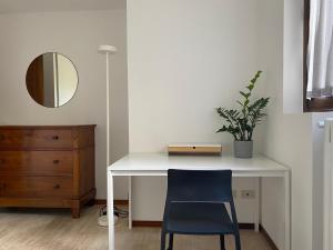 a white desk with a blue chair and a mirror at Holiday home Punta D'Oro with garden, parking place and lake access at 300 m in Iseo +47 photos