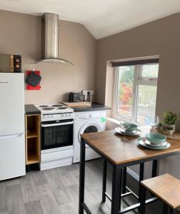 a kitchen with a white stove and a table at Annex - Garden View in Bristol