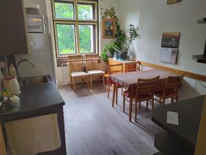 a kitchen and dining room with a table and chairs at Pension 21 in Prague