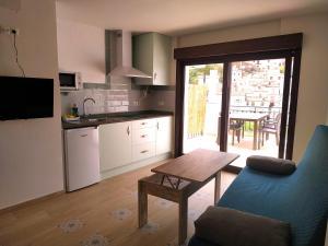 a kitchen with a table and a blue couch and a table at Casa Herrerillo Cazorla in Cazorla