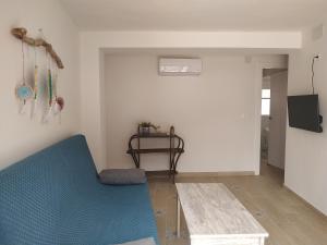 a living room with a blue couch and a table at Casa Herrerillo Cazorla in Cazorla