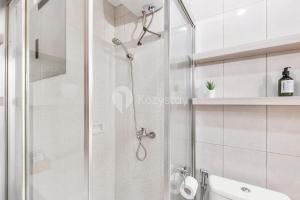 a shower with a glass door in a bathroom at Gala by Kozystay - Thamrin in Jakarta +17 photos