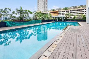 a large swimming pool with a building in the background at Gala by Kozystay - Thamrin in Jakarta