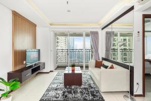 a living room with a couch and a tv at Gala by Kozystay - Thamrin in Jakarta