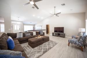 a living room with a couch and a flat screen tv at Luxury Home Near Las Vegas Strip and Airport. in Las Vegas